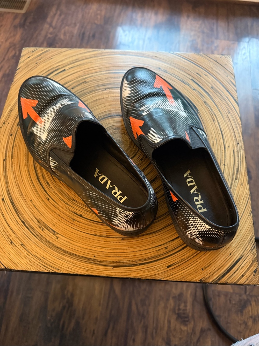 Prada Black Leather Slip-On Loafers with Orange Arrow Motif